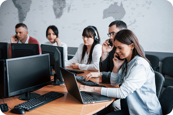 Team of IT support professionals working at computers